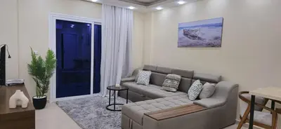 a living room with a couch and a table at Crystal chalet in Hurghada