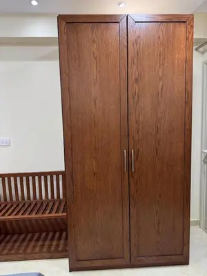 a wooden cabinet in a room with a bed at La Quinta Hurghada Pool & Sea View Ground floor in Hurghada