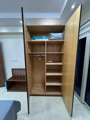 a wooden cabinet with shelves in a room at La Quinta Hurghada Pool & Sea View Ground floor in Hurghada