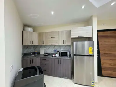 a kitchen with a stainless steel refrigerator and a microwave at La Quinta Hurghada Pool & Sea View Ground floor in Hurghada