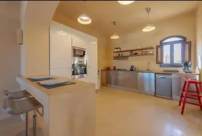 a large kitchen with stainless steel appliances and a counter at Stylish Villas in North Golf El Gouna in Hurghada