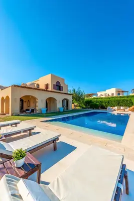 a villa with a swimming pool and a house at Stylish Villas in North Golf El Gouna in Hurghada