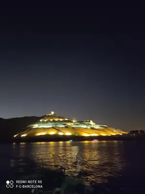 an island in the water at night at Sun of Aswan Stay in Aswan