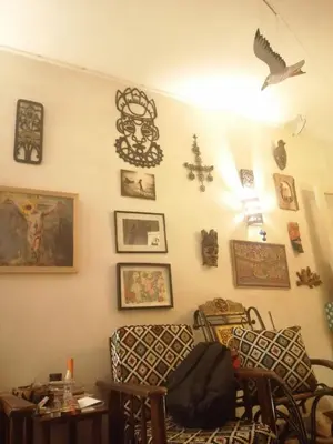 a living room with a wall with pictures and decorations at Sun of Aswan Stay in Aswan