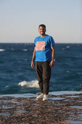 a man standing on the beach near the ocean at Sun of Aswan Stay in Aswan