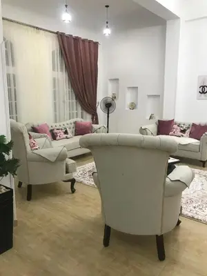a living room with two chairs and a couch at Sun Garden Villa in Luxor