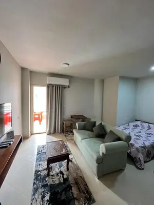 a living room with a couch and a bed at Studio Pool & Sea View Princess Resort in Hurghada