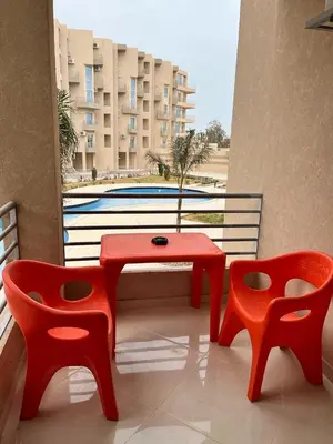 a red table and two chairs on a balcony at Studio Pool & Sea View Princess Resort in Hurghada