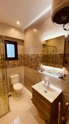 a bathroom with a toilet and a sink and a shower at Modern apartment for rent in Hurghada