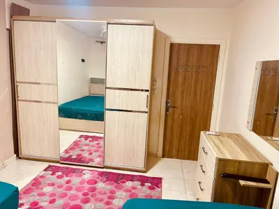 a room with a mirror and a bedroom with a bed at Nesim hights compound in Hurghada