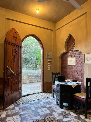 an entrance to a room with a large wooden door at Villa Harmony Luxor in Luxor