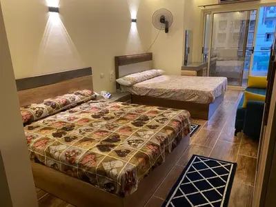 a bedroom with two beds and a window at Florenza compound in Hurghada