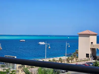 a view of the ocean with boats in the water at Old Sheraton street apartment in Hurghada