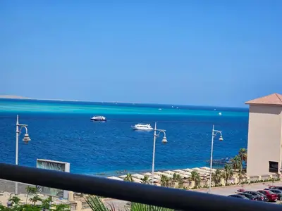 a view of the ocean with boats in the water at Old Sheraton street apartment in Hurghada