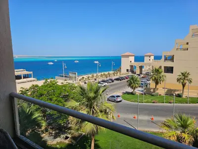 a balcony with a view of a street and the ocean at Old Sheraton street apartment in Hurghada