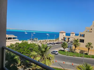 a view from a balcony of a street and the ocean at Old Sheraton street apartment in Hurghada