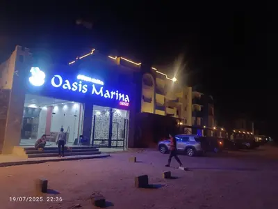 a person walking in front of a store at night at isis MARINA in Hurghada