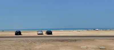 a group of three cars parked on the beach at isis MARINA in Hurghada