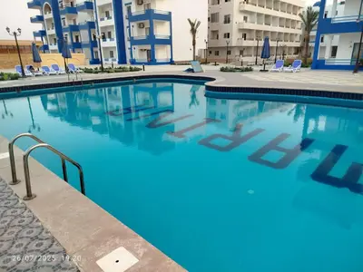 a large swimming pool with blue water in a building at isis MARINA in Hurghada