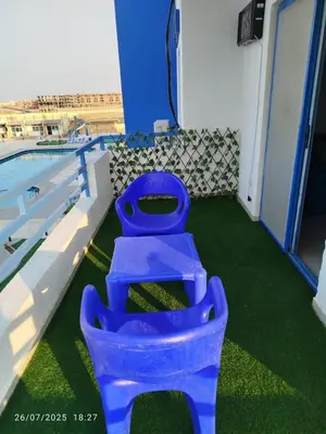 two blue toilets sitting next to a swimming pool at isis MARINA in Hurghada