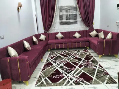 a living room with a purple couch and a rug at El faraón egipcio apartment in Al Karnak