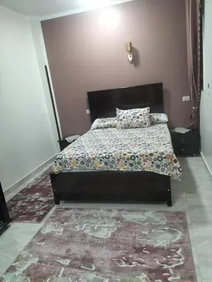 a bedroom with a bed and a rug at El faraón egipcio apartment in Al Karnak