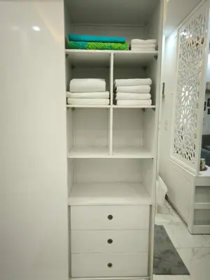 a white walk in closet with white towels at Hurghada Chill Out Home in Hurghada