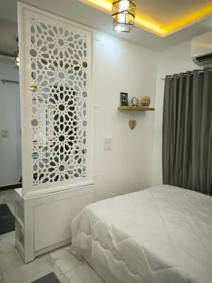 a bedroom with a bed and a wall with a window at Hurghada Chill Out Home in Hurghada