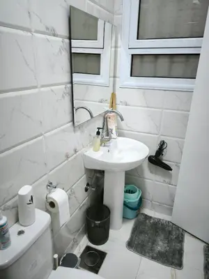 a bathroom with a sink and a toilet and a mirror at Hurghada Chill Out Home in Hurghada