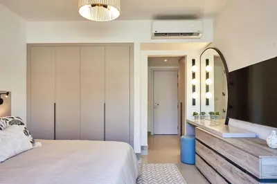 a bedroom with a large bed and a mirror at Modern 3BR Poolside Apt at Cribs El Gouna in Hurghada
