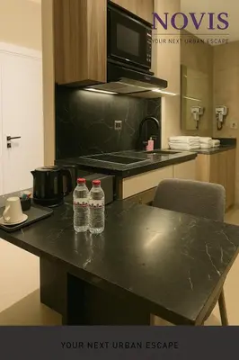 two bottles of water sitting on a table in a kitchen at Novis Holiday Homes Sahl Hasheesh in Hurghada