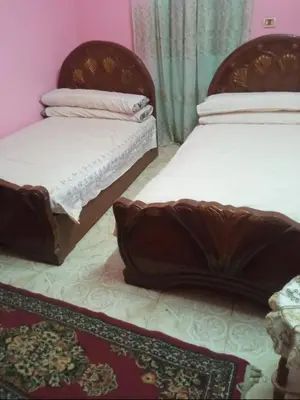 two beds sitting next to each other in a room at هاي موود in Jazīrat Aswān