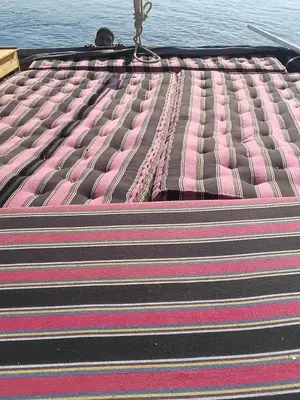 a close up of the top of a mattress on the water at Felucca Alaska in Aswan