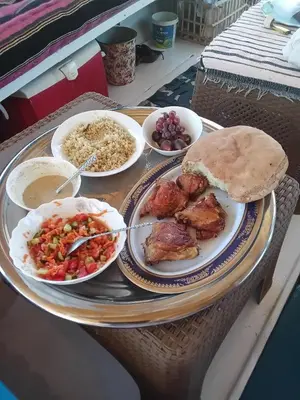 a tray with plates of food on a table at Felucca Alaska in Aswan