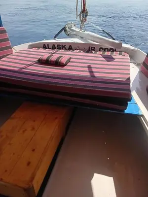 a board on the back of a boat on the water at Felucca Alaska in Aswan