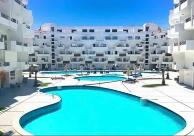 a large apartment building with a large swimming pool at Tiba view in Hurghada