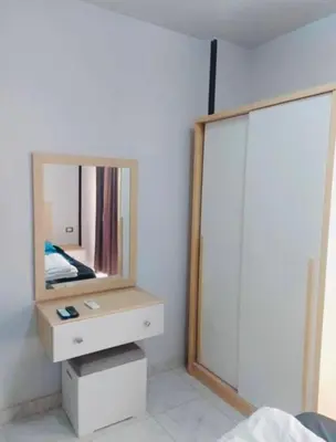 a bedroom with a mirror and a white dresser at Tiba view in Hurghada