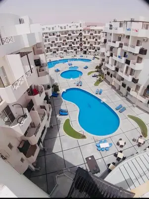 an aerial view of a building with two swimming pools at Tiba view in Hurghada