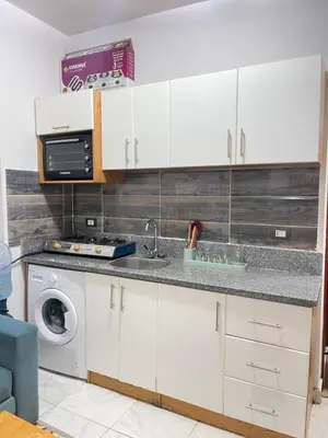 a kitchen with a sink and a washing machine at Tiba view in Hurghada