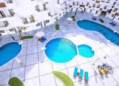an overhead view of two swimming pools in a building at Tiba view in Hurghada