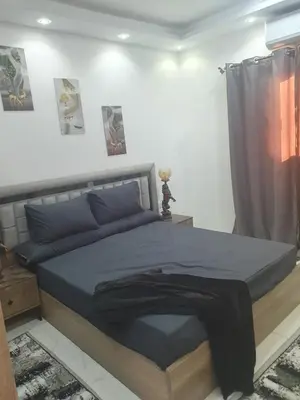 a bedroom with a bed with a blue comforter at Apartment sea view in Hurghada