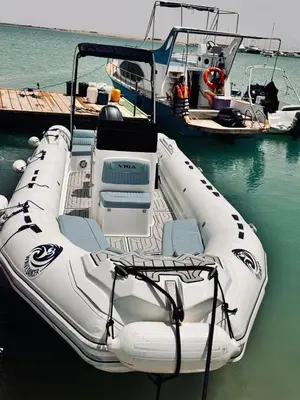 a white boat is docked in the water at Wave Dancer in Hurghada