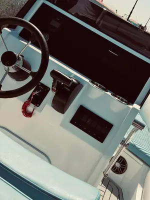 a dashboard of a boat with a steering wheel at Wave Dancer in Hurghada
