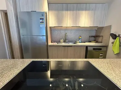 a kitchen with a stainless steel refrigerator and a sink at Fanadir Marina 2BR GF • Stunning View in Hurghada