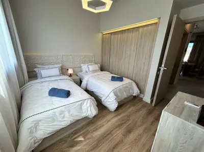 two beds in a hotel room with at Fanadir Marina 2BR GF • Stunning View in Hurghada