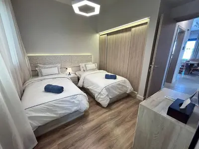 a room with two beds in a room at Fanadir Marina 2BR GF • Stunning View in Hurghada