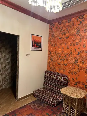a living room with a chair and a table at Aswan House center in Aswan