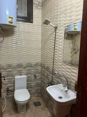 a bathroom with a toilet and a sink at Aswan House center in Aswan
