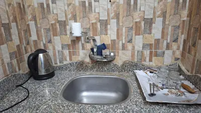 a kitchen counter with a sink and a soap dispenser at Aswan House center in Aswan