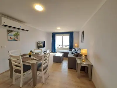 a living room with a table and a couch at Tawaya Sea View 2 bedrooms in Hurghada
